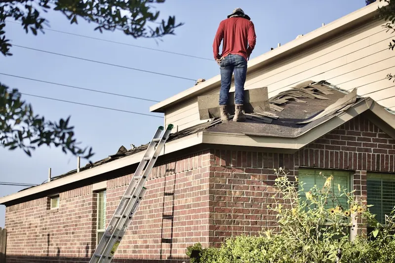 Professional roofer working on a residential roof in Rappahannock Corner
